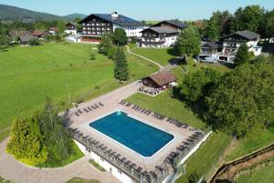 an aerial view of a house with a swimming pool at Hotel Lohninger-Schober 3 Stern Superior in Sankt Georgen im Attergau