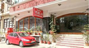 a red car parked in front of a building at Hotel Pablas International, New Delhi, Near Metro in New Delhi