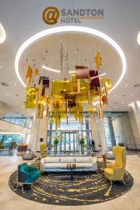 a large chandelier in the lobby of a hotel at @Sandton Hotel in Johannesburg