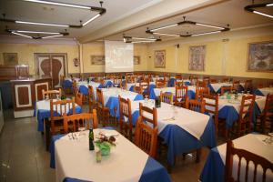 a dining room with tables and chairs with blue table cloth at Hostal Santa Barbara in Socuéllamos