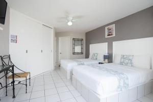 1 dormitorio con 2 camas, mesa y sillas en Hotel Master Club, en Tequesquitengo