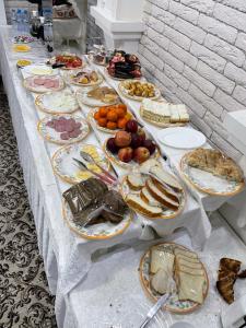 a long table with many plates of food on it at Hotel Maroqanda in Samarkand