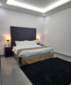 a bedroom with a large bed with a black headboard at Mirage Bab Al Bahr Beach Resort in Dibba