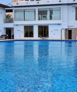 a large swimming pool in front of a building at Mirage Bab Al Bahr Beach Resort in Dibba