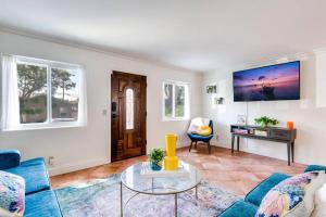 a living room with a blue couch and a table at The Kozi Sandbox in Oceanside