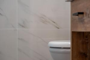 a bathroom with a white toilet in a room at Stefano's Home in Potokáki