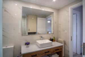 a bathroom with a sink and a mirror at Stefano's Home in Potokáki