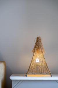 a triangle shaped lamp on top of a table at Stefano's Home in Potokáki
