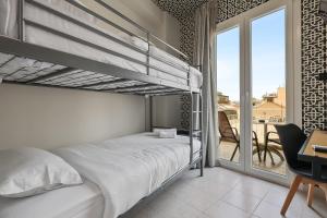 a bedroom with a bunk bed and a balcony at 7ATHENS in Athens +82 photos