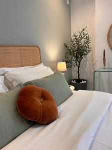 a pillow sitting on top of a bed at O live Kalamata in Kalamata