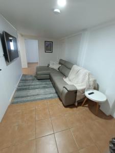 a living room with a couch and a table at Avondale Apartment in Lismore