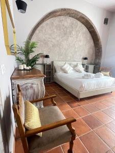 a bedroom with a bed and a chair at Lucilla’s Suite San Pietro station in Rome