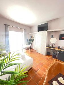 a living room with a white couch and a kitchen at Lucilla’s Suite San Pietro station in Rome