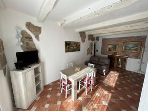 a living room with a table and a television at Aura Entis in Canino