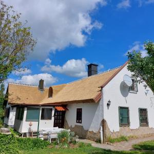an old white house with a brown roof at Hermann Cottage in Keszthely