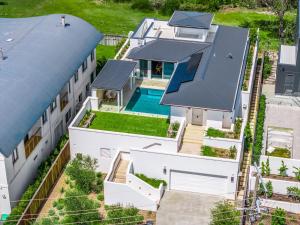 an aerial view of a house with a swimming pool at Aquarium House - with direct beach access & pool in Pottsville