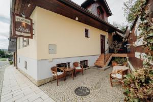 a restaurant with a table and chairs outside of a building at Penzion Alžbetka in Poprad