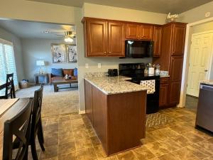 a kitchen with a kitchen island with a stove top oven at Stunning 3br Oasis Rainshower Family Fun in Oklahoma City