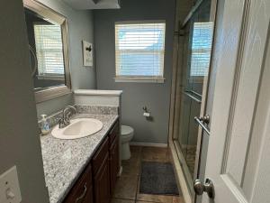 a bathroom with a sink and a shower at Stunning 3br Oasis Rainshower Family Fun in Oklahoma City