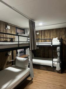 a room with three bunk beds in a room at Rom Casa Hostel Da Nang in Da Nang