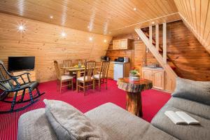 a living room with a couch and a table in a cabin at Chalet Musala in Borovets