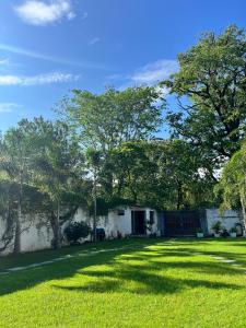 a house with a yard with grass and trees at AruBhi Cottage in Dehradun