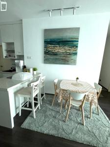 a kitchen and dining room with a table and chairs at Livistona Luxe Apartment in Permatang Pauh