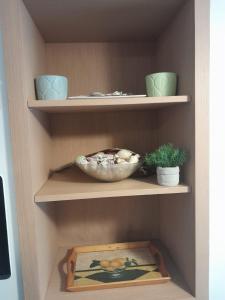 a shelf with a bowl and a plate on it at Capraia per te in Capraia +34 photos