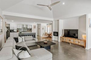 a white living room with a couch and a table at Sundrift: Tranquil Retreat with Spectacular Views in Quindalup