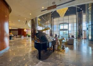 a piano in the lobby of a hotel at Your Story of Luxury Begins Here in Dubai