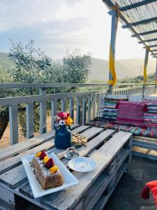 a table with a slice of cake on a balcony at Elaia Rest House in Fréngaina
