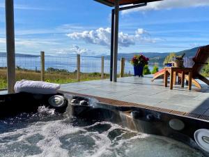 a hot tub with water coming out of it at Knockderry Lodge -Private Luxury pet-friendly accommodation in Scotland with hot tub in Cove