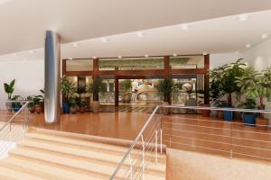 a lobby with a staircase and potted plants at AluaSoul Costa Adeje in Adeje