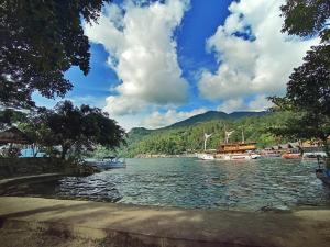 a view of a lake with boats in the water at Pandu Lakeside Hotel Parapat in Parapat