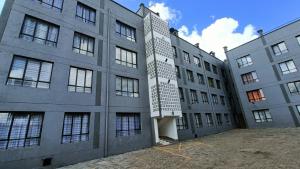 a large gray building with a lot of windows at Lulu Stays 2 Bedroom in Nyahururu