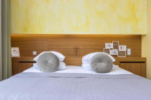 a bed with two pillows on top of it at Bern Boutique Hotel in Tallinn