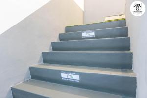 a set of stairs with two signs on them at MetroCity Backpackers in Kuching