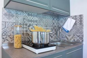 a kitchen counter with a blender and a sink at Villa Onedo in Abbadia Lariana