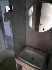 a bathroom with a sink and a mirror at Hotel Merlot in Eger