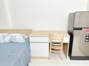 ハノイにあるnha7bngo140tdhのベッドルーム(デスク、ベッド、冷蔵庫付)