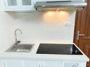 a kitchen with a sink and a stove at nha7bngo140tdh in Hanoi