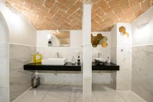 a bathroom with a sink and a mirror at TIFFANY TORTELLINOSUITE Modena in Modena