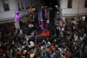 an overhead view of a crowd of people at a concert at Dhami Apartment in Gjirokastër