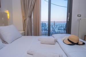 a bedroom with a bed with a hat on it at Filia Home in Agios Nikolaos