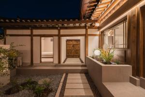 a house with a pathway leading to the front door at Luxury hanok with private bathtub - SW13 in Seoul