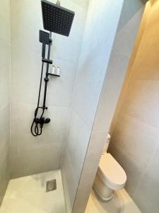 a bathroom with a shower with a toilet and a camera at ريزا in Al Madinah