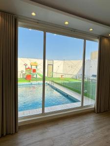 a large window with a view of a swimming pool at ريزا in Al Madinah