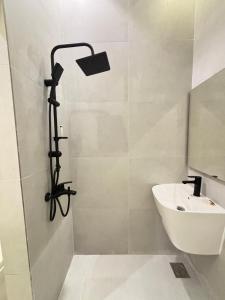 a bathroom with a shower with a sink and a shower head at ريزا in Al Madinah
