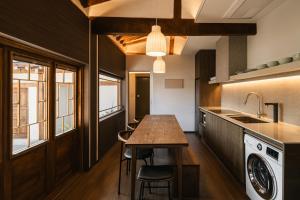 a kitchen with a wooden table and a sink at Luxury Hanok Retreat Dohyun in Seoul