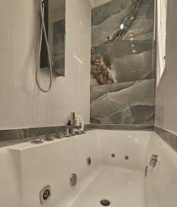 a white bath tub in a bathroom at Luxurious Top Floor Acropolis View Loft in Plaka - Newly Refurbished in Athens